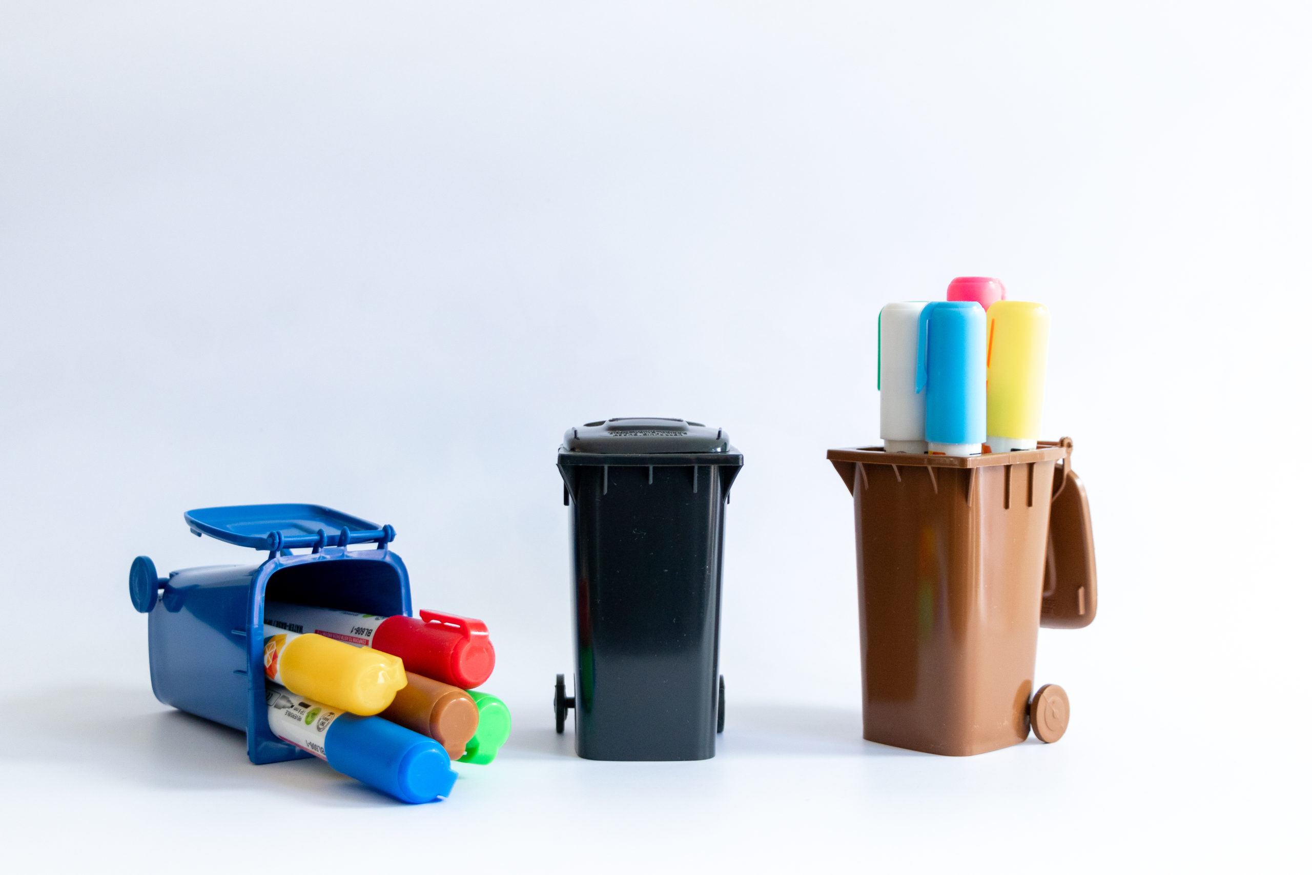 Colorful felt tip pens in 3 small trash cans